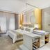 Jiangnanxi Hotel Guangzhou guest room with bed, desk, chair, and large curtained window
