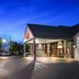 Red Roof Inn & Suites Duncan exterior at dusk with lit entrance, parking lot, and sign