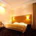 La Petite Apartments & Rooms, Gdansk: cozy guest room with double bed, seating area and warm lighting