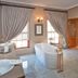 La Plume Boutique Hotel & Spa in Oudtshoorn: elegant bathroom with freestanding tub, double vanity and shower
