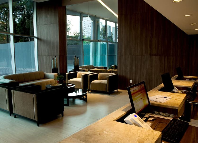 Bh Raja Hotel lobby lounge in Belo Horizonte with seating area and reception desks
