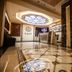 Safir Hotel Dushanbe lobby with ornate marble floor, reception desk and decorative ceiling