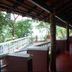 Sea Shell Haris Beach Home in Kannur: shaded beachfront veranda with wooden chairs and sea-facing view