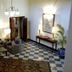 Ananda in the Himalayas lobby with checkered floor, patterned seating, lamps, and framed art in Rishikesh