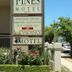 Armidale Pines Motel sign outside with flowers and vacancy sign in Armidale