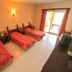 Sami Plaza in Bodrum, three beds in a simple guest room with balcony doors and tiled floor