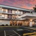 Red Roof Inn Baltimore South - Glen Burnie exterior with covered entrance and parked van at sunset