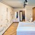 art Hotel Tucholsky Bochum guest room with double bed, wood accent wall, mural and herringbone floor