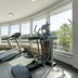 Plaza Premium Köln gym with treadmill and elliptical machines, floor-to-ceiling windows in Cologne