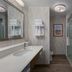 Hampton Inn Turlock bathroom with vanity, walk-in shower and toilet
