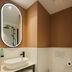 Logis Hôtel de Port d'Alon bathroom with vessel sink, wall toilet and oval mirror in Saint-Cyr-sur-Mer