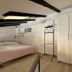 Downtown Apartments Pula in Pula bedroom with double bed, wardrobe, and exposed ceiling beams