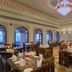 The Tigress, Ranthambore dining room in Sawāi Madhopur with ornate ceiling and set tables