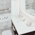 Mill Creek Hotel in Lake Geneva bathroom with soaking tub, tiled walls, and white vanity