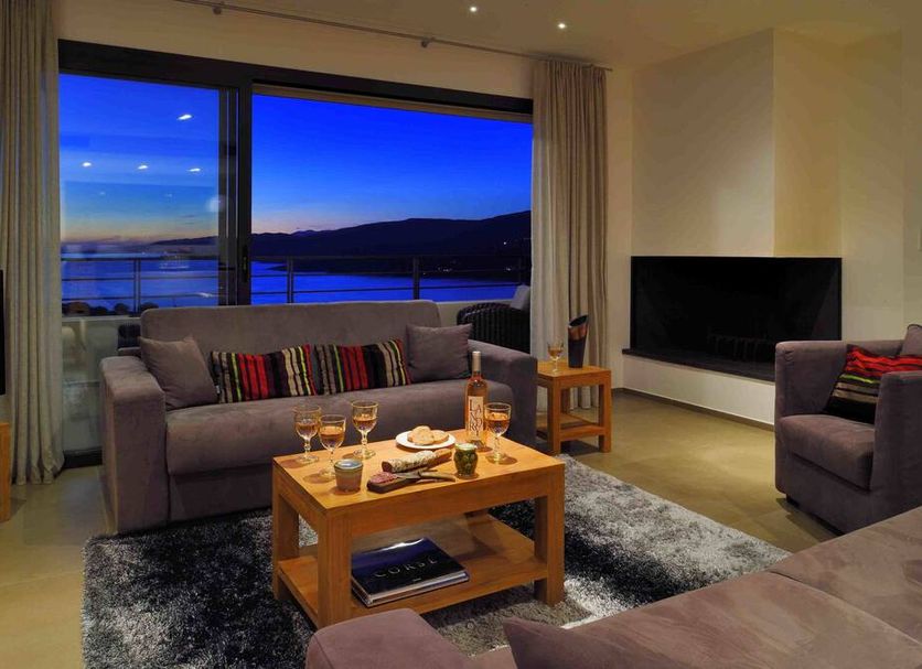 Résidence & Hôtel Aria Marina in Propriano: living room with balcony sea view at dusk