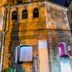 Sozo Hotel Nantes exterior in a historic stone church with illuminated arched windows at night