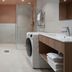 Sky Hotel Apartments Stockholm bathroom with walk-in shower, washer, toilet and sink