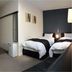 Value the Hotel Ishinomaki guest room with two twin beds, desk, and seating area