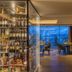 Hotel Olangerhof in Valdaora lounge with city-view windows, tables and chairs at dusk