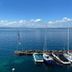 Hôtel Des Princes in Évian-les-Bains overlooking a calm blue lake with sailboats at a marina