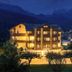 Th Cadore - Hotel Antelao in Borca di Cadore at night with glowing balconies and mountain backdrop