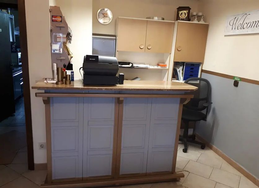 Jaegerstube in Görgeshausen reception desk with counter, office chair and welcome wall sign