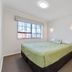 Knightsbridge Court Motor Lodge in Blenheim bedroom with queen bed, bedside table, and window