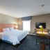 Hampton Inn and Suites Jamestown guest room with king bed, desk, TV and two windows