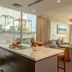 Swiss-Belsuites Admiral Juffair in Manama suite with kitchen island, seating area and city view