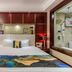 Shijiazhuang Shen Zhou 7 Star Hotel room with bed, red wood paneling, and bathroom view in Shijiazhuang