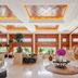 Fuhong International Hotel in Liaoyang lobby with grand staircase, skylit ceiling, and potted plants