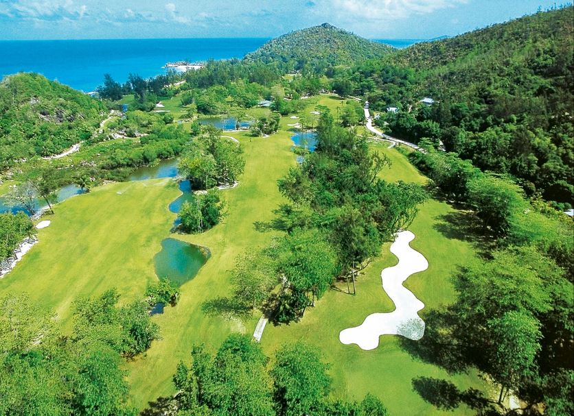 Constance Lemuria, Grand'Anse Praslin: aerial view of golf course, lush hills and turquoise ocean