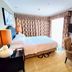 Ramada Plaza by Wyndham Tian Lu Hotel Wuhan room with bed, desk, TV, and bright window in Wuhan