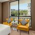 Courtyard by Marriott Shanghai Changfeng Park room with city park view, two yellow chairs by window