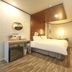 Hotel Atti Incheon guest room with bed, wall-mounted TV, desk and wood-look flooring