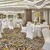 Kingsford Hotel Manila Bay in Manila ballroom with round banquet tables, white chair covers, and floral centerpieces