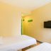 Hi Inn Beijing Shangdi Anningzhuang room with two beds, wall-mounted TV, and beige walls in Beijing