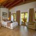 Reserva del Saja Hotel & Spa room in Renedo de Cabuérniga with wood-beamed ceiling, sofa, bed and balcony doors