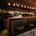 Triple E Hotel Fine Art Museum bar with high stools and hanging lights in Ho Chi Minh City