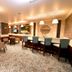 City Seasons Al Hamra Hotel in Abu Dhabi lounge with bar seating, tables, and pendant lights