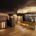 La Majun in Corvara in Badia hotel lobby with warm lighting, reception desk and lounge seating
