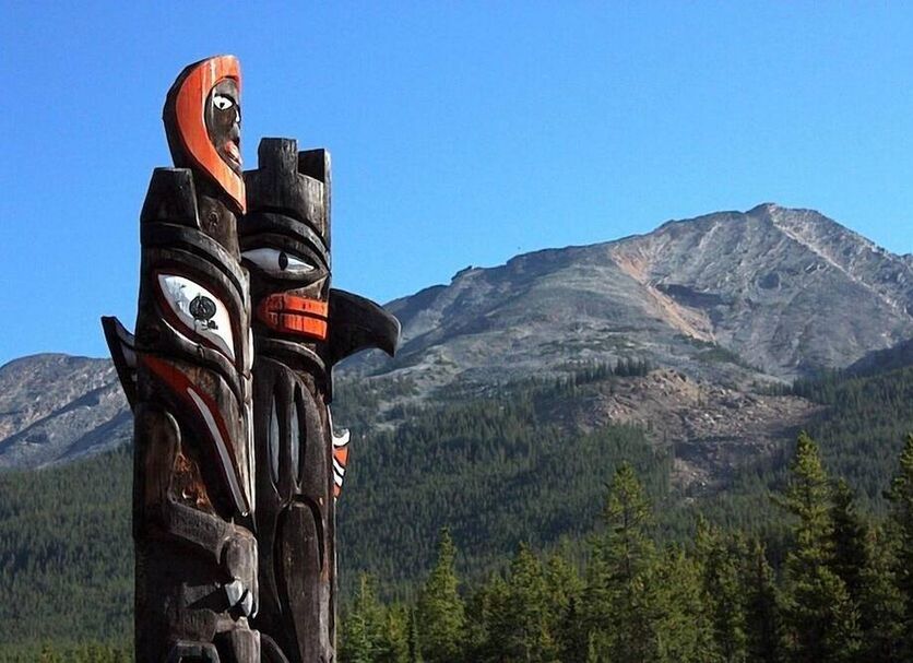 Sunwapta Falls Rocky Mountain Lodge in Jasper with mountain views and a carved totem pole