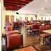 The Putra Regency Hotel Kangar dining area with red chairs and wooden tables