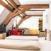 Hotel Hofgut Hohenkarpfen room in Hausen ob Verena with exposed beams, twin beds and seating area