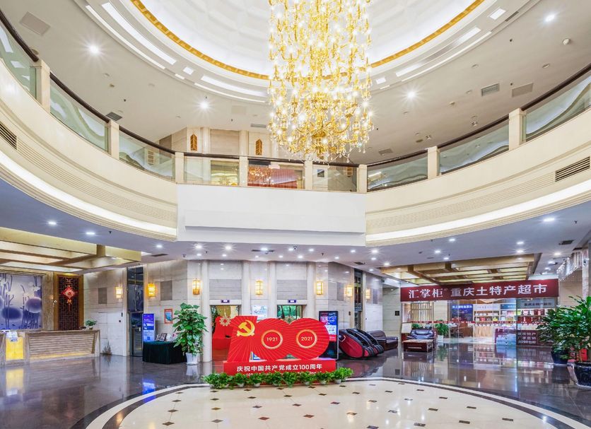 East Garden Hotel Chongqing lobby with grand chandelier, curved balconies and reception area