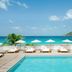 Cheval Blanc St-Barth in Gustavia: beachfront pool with lounge chairs, umbrellas, and ocean view