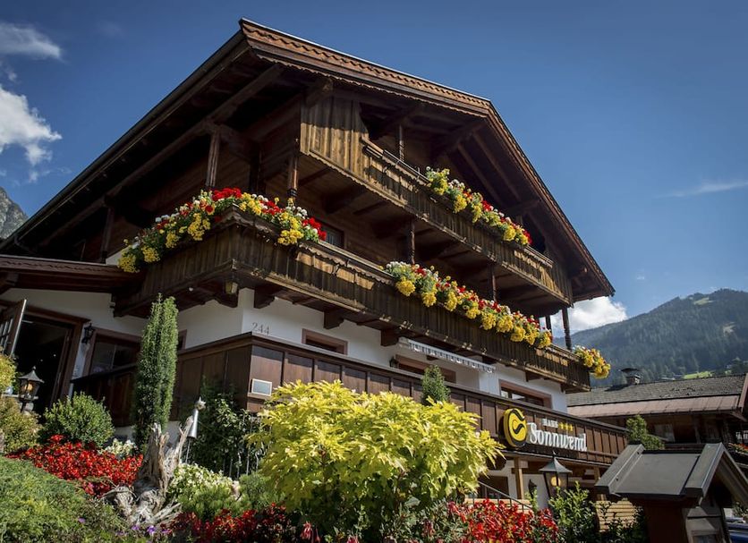 Haus Sonnwend in Alpbach, a chalet-style hotel with flower-filled balconies and mountain views