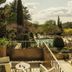 Baumanière - Les Baux de Provence terrace with table, chairs, and garden pool view in Les Baux-de-Provence