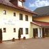 Zu den Linden Nichtraucherhotel in Aschheim exterior courtyard with yellow facade and red-tiled roof