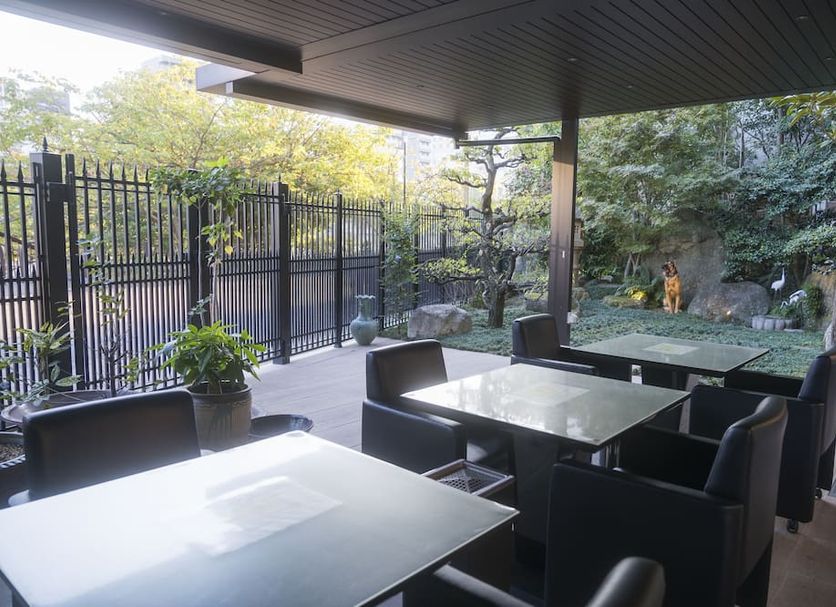 Hotel Hakata Nakasu Inn in Fukuoka, outdoor terrace seating with tables overlooking a garden